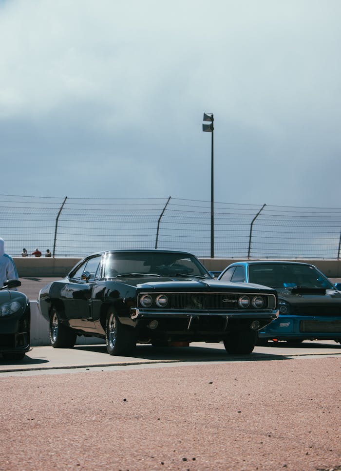 Front view of a vintage black Dodge Challenger showcasing its iconic muscle car design at an outdoor car show.